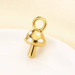 Detail of mushroom pendant with white enamel dots and golden stainless steel finish