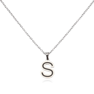 Macro shot of silver stainless steel S letter pendant with black enamel inlay detail