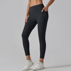 Detail view of high waisted black yoga leggings with functional side pocket and matte fabric