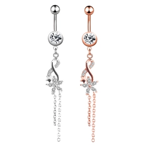 Detailed view of silver and rose gold belly rings with zircon stones and tassels