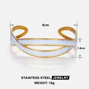 Detailed view of wide 18k gold-plated stainless steel cuff with white enamel finish