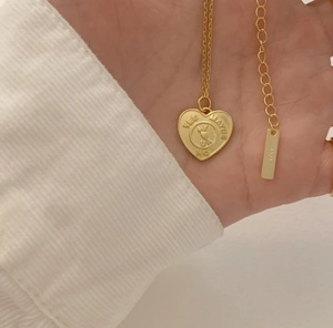 Macro shot of 925 sterling silver heart necklace with YES MAYBE NO engraving