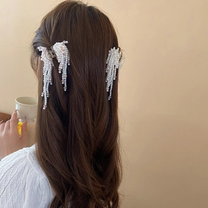 Elegant faux pearl tassel hair claw clips styled on a bun for a chic French look
