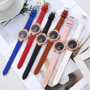 Detail view of colorful quartz watches with starry sky dials and sparkling rhinestones