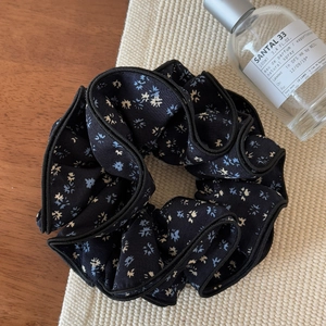 Vintage navy floral four-layer scrunchie hair tie on a wooden background