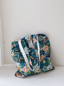 Detailed close-up of floral oil painting tote bag featuring colorful flower patterns