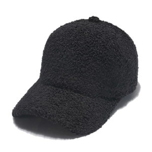 Close-up of the fuzzy black lambswool texture and detailed stitching on the baseball cap