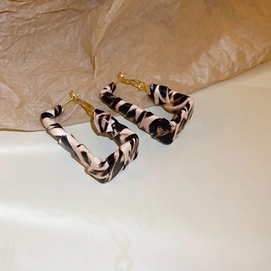 Detail shot of leopard print faux leather square hoop earrings with golden silver needles