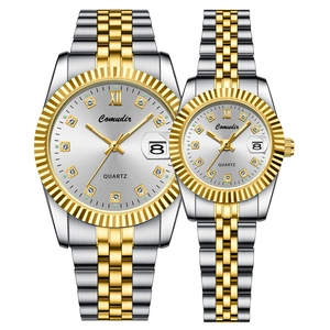 Detail of silver and gold couple watches with Roman numerals and calendar display