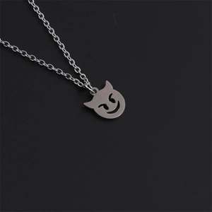 Polished stainless steel necklace featuring a devil cat emoji pendant on black background