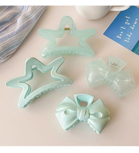 Set of four light blue cream star and bow hair claws made of smooth acrylic material