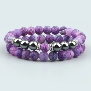 Detail of double-layer bracelet with purple agate beads and metallic grey spheres