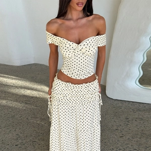 Detailed view of the polka dot high-waist maxi skirt and gathered elastic waistline texture