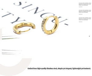 Macro detail of gold-plated stainless steel hoop earrings with sparkling micro-pave crystals