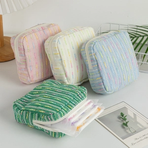 Striped tweed cosmetic bag set in pink blue and green with a textured woven finish
