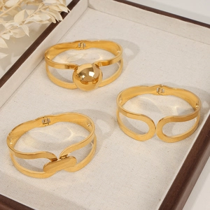 Elegant gold plated double-layer geometric titanium steel bangles on display tray
