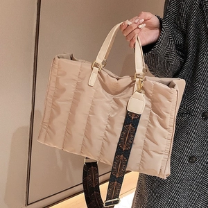 Fashionable beige quilted nylon tote bag with stylish wide patterned shoulder strap for women