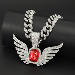 Macro shot of silver hip-hop necklace with red ruby wing pendant and sparkling rhinestones