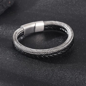 Close-up of double-layer men's bracelet with silver mesh, black leather, and magnetic clasp