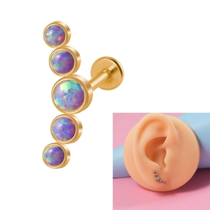 Detail of internal thread labret with five purple opal stones and silicone ear display