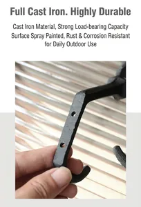 Detail of durable cast iron wall hook with matte black finish and multi-hole design