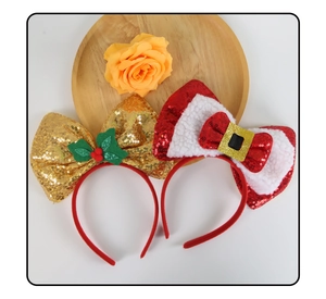 Detail of Christmas sequin headbands featuring golden bow and Santa belt buckle style