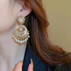 Vintage royal style gold earrings with pearls and crystals shown on model