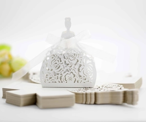 Detailed laser-cut white hollow dress candy box with elegant ribbon and floral pattern