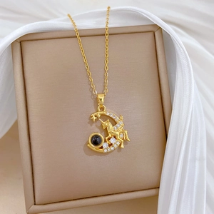 Detailed close-up of a gold Pegasus and moon pendant with crystals and projection stone