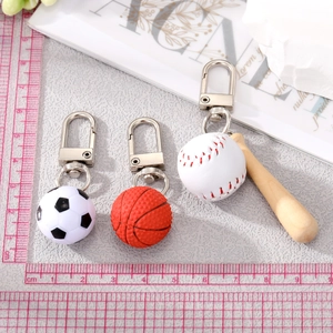 Miniature sports ball keychains with football, basketball, and baseball bat pendants