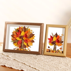 Deep brown and natural wood leaf specimen frames with dried plant art decor