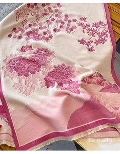 Close-up of pink cashmere-like scarf showing exquisite floral patterns and fine fringe details