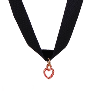 Close-up of black velvet ribbon choker featuring a rose gold hollow heart charm
