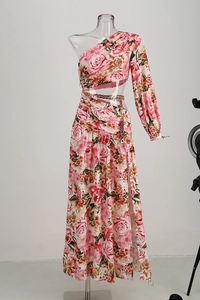 Detail of waist cutout with metal chain decoration on a pink floral one-shoulder dress