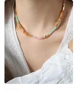 Close-up of handmade beaded necklace featuring colorful amazonite beads and gold accents