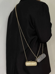 Detailed view of luxury gold and black rhinestone mini evening bags with metal chains