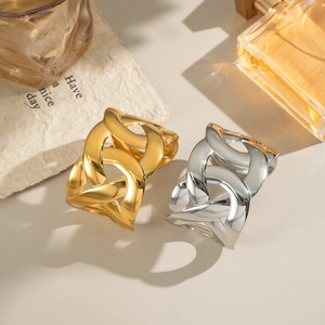 Detail of interlocking chunky chain link cuffs in polished gold and silver finishes