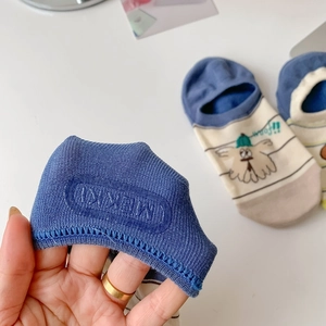 Detail of non-slip silicone heel grips on cartoon jacquard low cut invisible socks