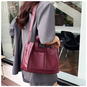 Retro burgundy PU leather tote bag detail with lychee texture and dual front pockets