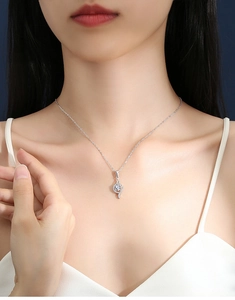 Detailed shot of an elegant S925 silver necklace with a curved sparkling moissanite pendant