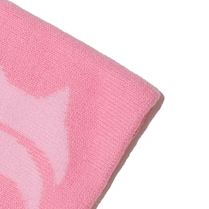 Detailed macro view of the pink jacquard knit texture on a winter beanie cap