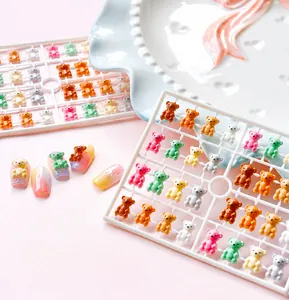 Macro view of detailed resin bear charms for 3D nail art in soft macaron colors
