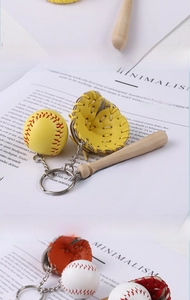Detailed view of mini baseball, leather glove, and wooden bat key ring gift set