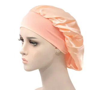 Side view of honey pink satin sleep cap with wide elastic band on a mannequin head