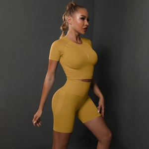 Close-up of seamless mustard yellow high-waisted fitness shorts with knitted texture