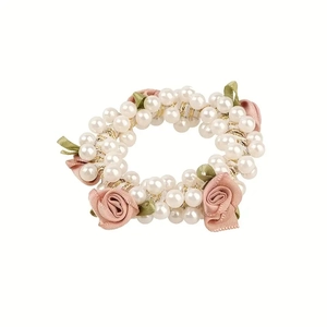 Pink fabric rose hair scrunchie with white pearls and gold woven threads on white background