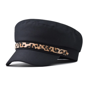 Detail view of black navy cap with leopard print chain strap and textured fabric