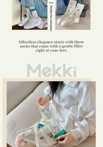 Close-up of breathable cotton socks featuring cute bear embroidery and heart patterns