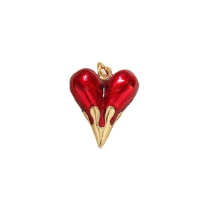 Melting red enamel heart pendant with gold metal drip detail on white background