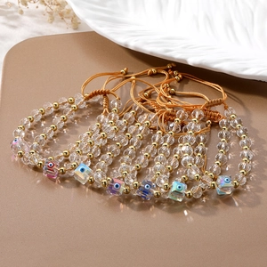Detail of colorful evil eye charms on crystal beaded bracelets with adjustable braided cord